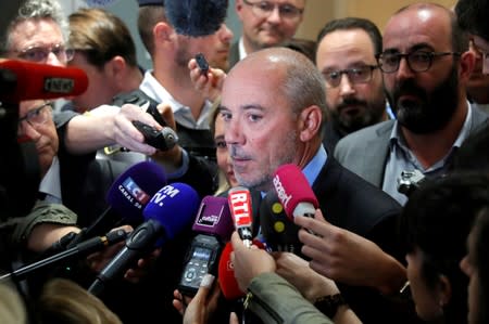 Orange chief executive Stephane Richard speaks to reporters inside the courthouse in Paris