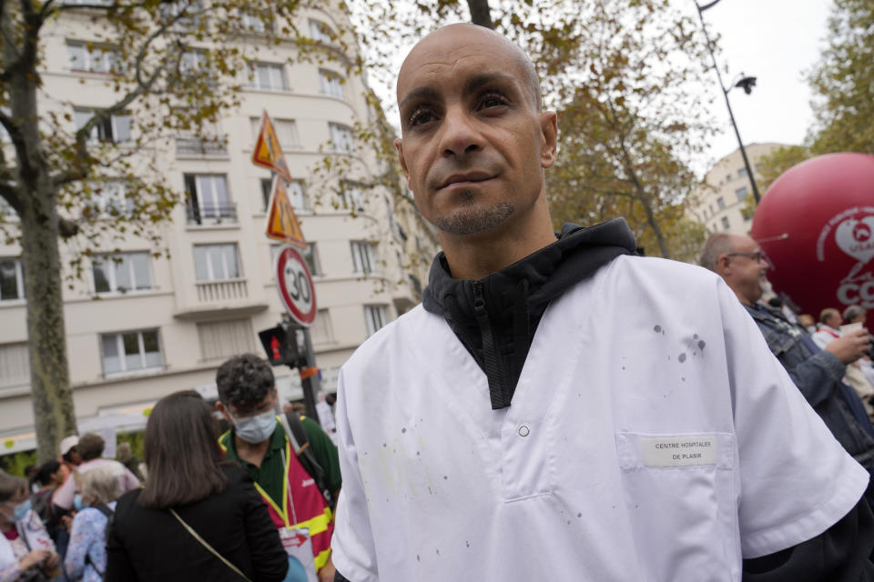 Rachid Ouchem, a medical worker from the Plaisir Hospital, attends a protest gathering outside the Health Ministry in Paris, Tuesday, Sept. 14, 2021 against a law requiring them to get vaccinated by Wednesday or risk suspension from their jobs. The law is aimed at protecting patients from new surges of COVID-19. Most of the French population is vaccinated but a vocal minority are against the vaccine mandate. (AP Photo/Francois Mori)