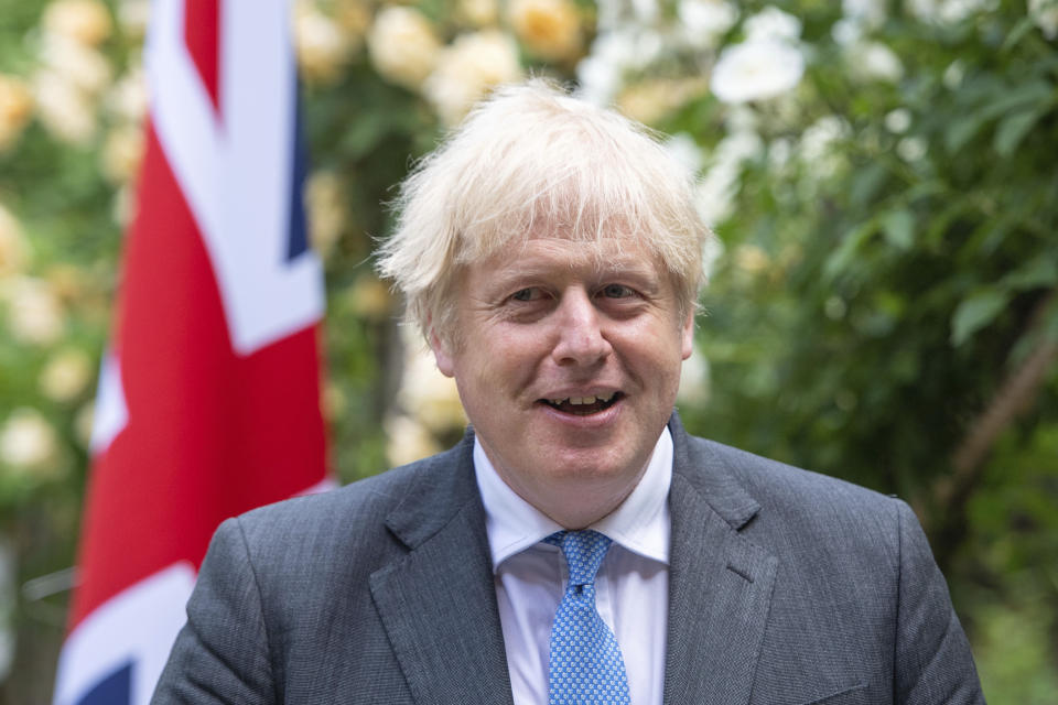 Britain's Prime Minister Boris Johnson, reacts as he walks with Australian Prime Minister Scott Morrison after their meeting, in the garden of 10 Downing Streeet, in London, Tuesday June 15, 2021. Britain and Australia have agreed on a free trade deal that will be released later Tuesday, Australian Trade Minister Dan Tehan said. (Dominic Lipinski/Pool Photo via AP)