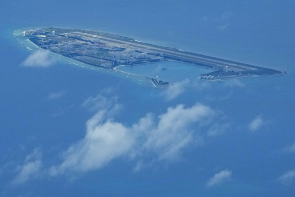 Chinese structures and buildings on the man-made Fiery Cross Reef at the Spratlys group of islands in the South China Sea are seen on March 20, 2022. The Philippine government has summoned a senior Chinese diplomat in Manila to protest the harassment by the Chinese coast guard of a research vessel manned by Filipino and Taiwanese scientists in the disputed South China Sea, officials said Tuesday May 31, 2022. (AP Photo/Aaron Favila)