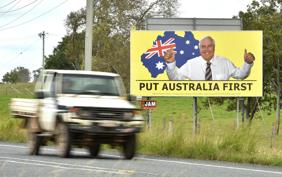 Photo taken on May 3, 2019 shows a ute driving past an election sign for mining magnate Clive Palmer's United Australia Party in Bowen in northern Queensland. - In conservative-leaning Queensland state, disillusioned voters are moving further right to support the anti-immigration One Nation Party and Clive Palmer's United Australia Party ahead of the election on May 18, 2019 (Photo by PETER PARKS / AFP) / TO GO WITH: Australia-politics-vote, FOCUS by Glenda KWEK        (Photo credit should read PETER PARKS/AFP via Getty Images)