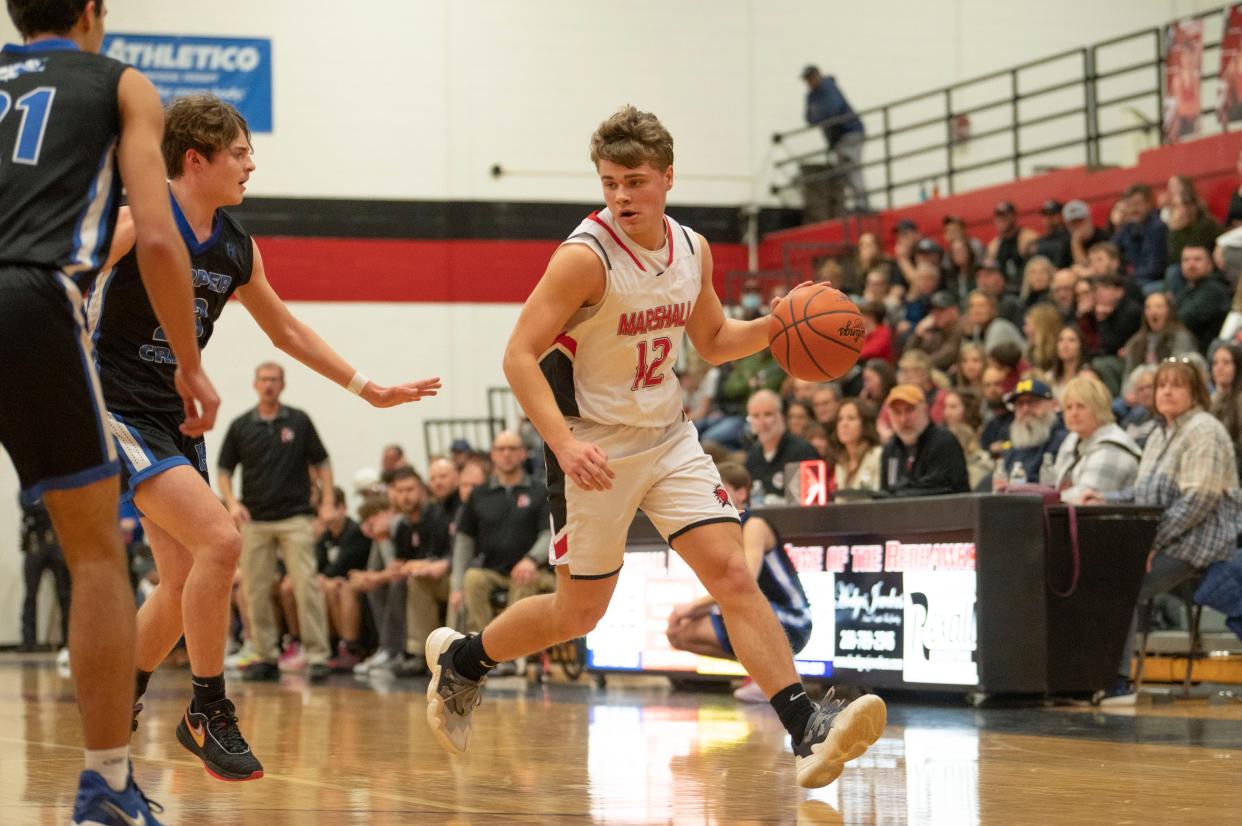 Marshall senior Josh Pugh dribbles during a game against Harper Creek at Marshall High School on Friday, Jan. 27, 2023.