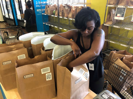 A Whole Foods shopper prepares a delivery order at the grocer's Rockwood Commons store in Cincinnati, Ohio, June 28, 2018. Picture taken June 28, 2018. REUTERS/Lisa Baertlein