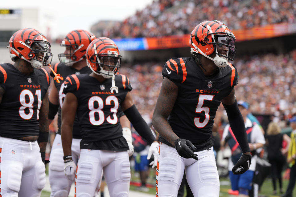 Cincinnati Bengals wide receiver Tee Higgins (5) celebrates after scoring as teammates Irv Smith Jr. (81) and Tyler Boyd (83) watch during the second half of an NFL football game against the Baltimore Ravens Sunday, Sept. 17, 2023, in Cincinnati. (AP Photo/Jeff Dean)