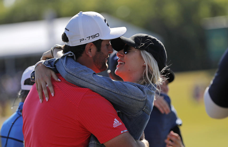 Jon Rahm, left, embraces his girlfriend Kelley Cahill after he and teammate Ryan Palmer won the PGA Zurich Classic golf tournament at TPC Louisiana in Avondale, La., Sunday, April 28, 2019. (AP Photo/Gerald Herbert)