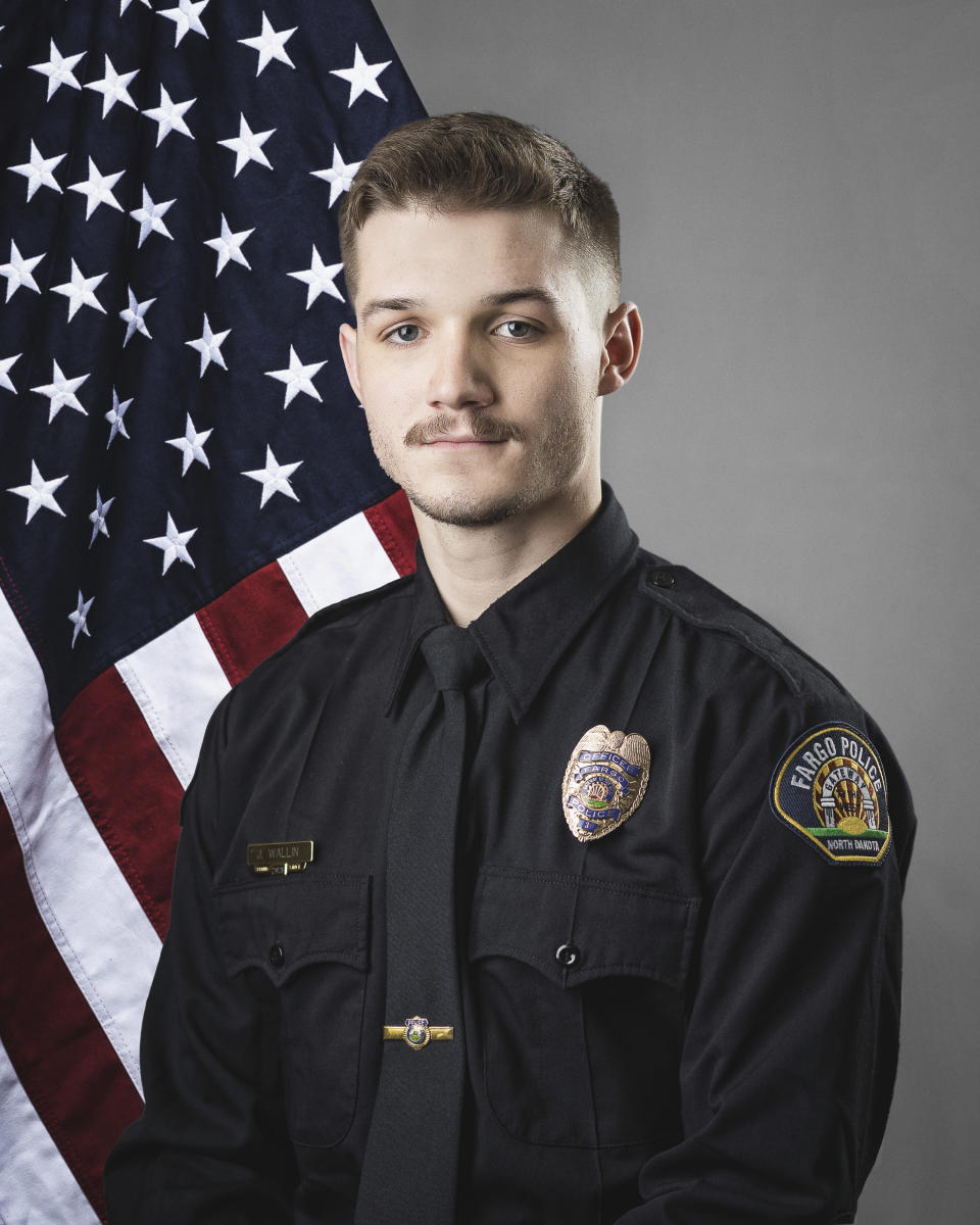 This photo provided by The City of Fargo, N.D., on Saturday, July 15, 2023 shows police officer Jake Wallin. On Saturday, Fargo's police chief said a gunman opened fire on police and firefighters as they responded to a traffic crash in North Dakota. One officer, Wallin, was killed and two others were wounded before a fourth officer killed him. (The City of Fargo via AP)