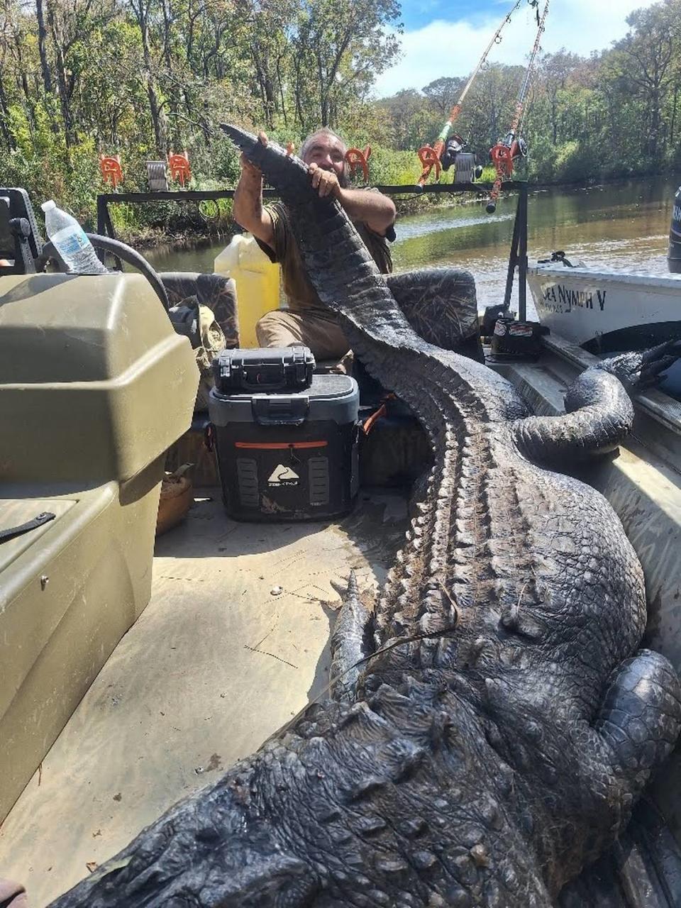 Jeffery Bullard with the 12-foot-long alligator he and John Wayne Caulder hunted on the Waccamaw River near the Horry and Georgetown County border. Photo provided by John Wayne Caulder. Oct. 10, 2023.