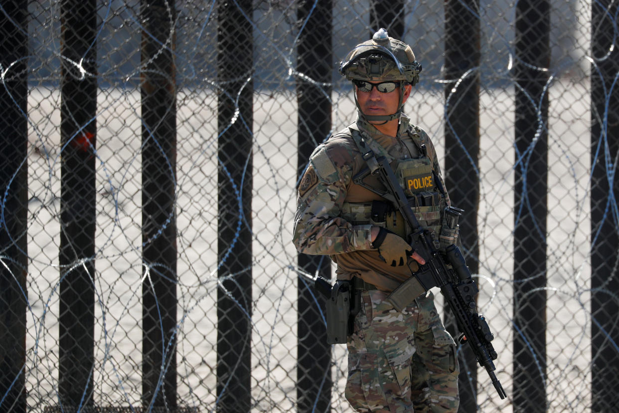 An armed U.S. Customs and Border Patrol agent stands watch at the border fence next to the beach in Tijuana, at the Border State Park in San Diego, California, U.S. Nov. 16, 2018. REUTERS/Mike Blake (Photo: Mike Blake / Reuters)