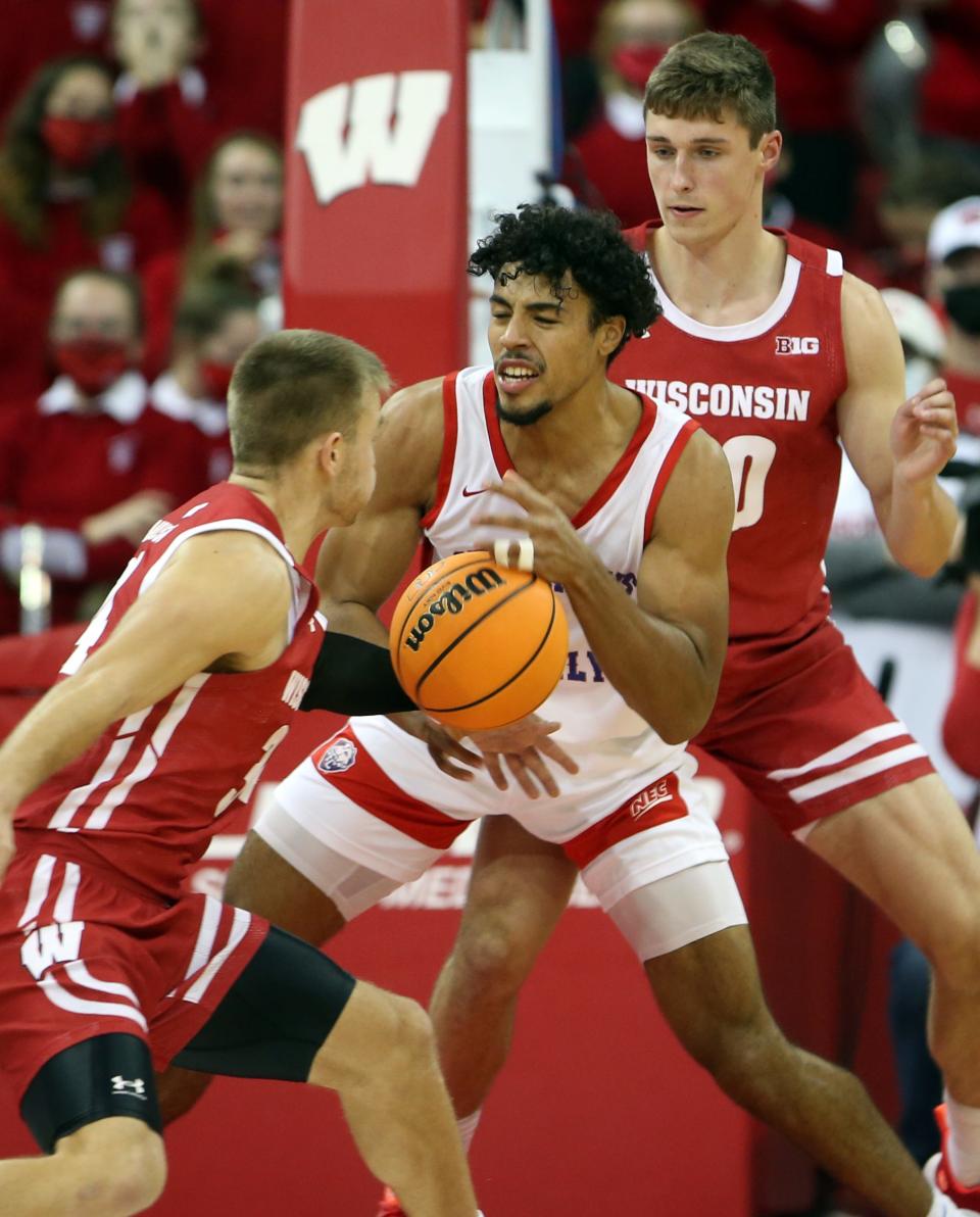 St. Francis guard Tedrick Wilcox Jr. , middle, attempts to control the ball while being defended by a couple of Wisconsin players in a November, 2021 game. Wilcox will play for Hampton next season.