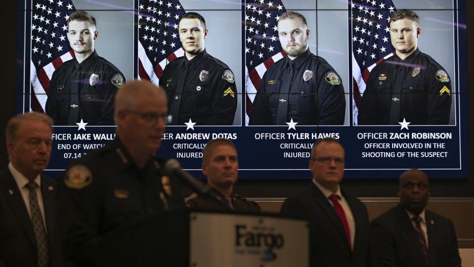 Official portraits of Fargo, N.D., police officers involved in a shooting a day earlier are displayed during a news conference, Saturday, July 15, 2023, at Fargo City Hall. Officer Jake Wallin, far left, was fatally shot. Officers Andrew Dotas and Tyler Hawes were both critically injured. Officer Zachary Robinson, who killed the suspect and is on paid administrative leave, is also pictured. (Ann Arbor Miller/AP)