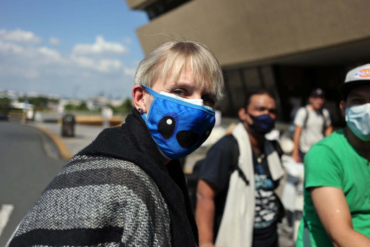 20 March 2020, Philippines, Manila: A woman with a mask is walking to the airport building. More than 300 Germans are waiting at Ninoy Aquino International Airport for a Lufthansa flight chartered by the German Embassy in the Philippines because of the Covid 19 pandemic. Photo: Alejandro Ernesto//Alejandro Ernesto/DPA (Photo by Alejandro Ernesto/picture alliance via Getty Images)