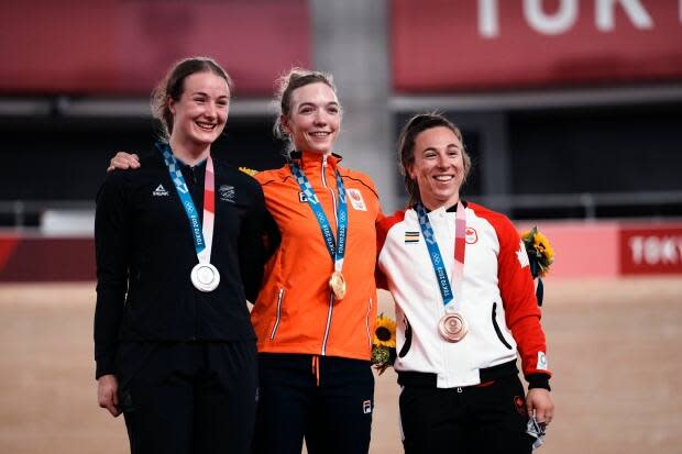 Gold medallist Shanne Braspennincx of Team Netherlands, centre, celebrates on the podium with silver medallist Ellesse Andrews of Team New Zealand, left, and bronze medallist Lauriane Genest of Team Canada, during a medal ceremony for the track cycling women's keirin at the 2020 Tokyo Olympics on Thursday in Izu, Japan. (Thibault Camus/The Associated Press - image credit)