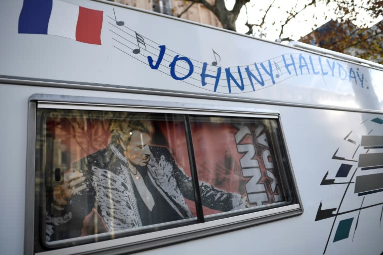 A camper decorated with the portrait of Johnny Hallyday parked in a street during a 'popular homage' to the French rock legend