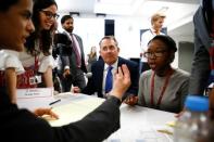 Britain's Secretary of State for International Trade Liam Fox visits students taking part in a mock trade negotiation at Harris Westminster Sixth Form college in central London