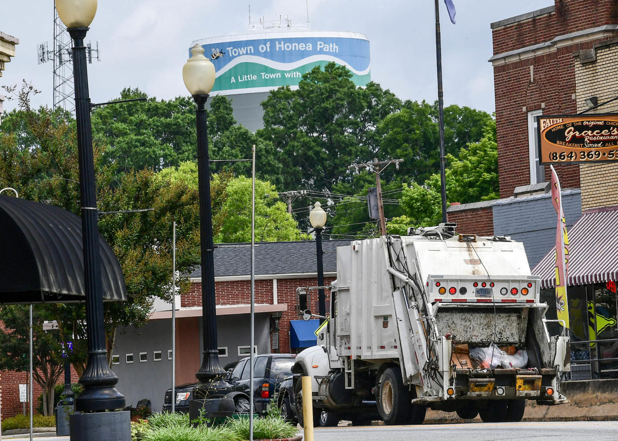 A Honea Path garbage truck drives along Main Street Wednesday morning. 