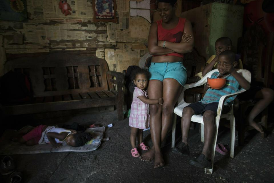 A family gathers during lunch, in the room the live in, at a building occupied by squatting families in Caracas, Venezuela, Monday, May 6, 2019. Venezuela is in the midst of a growing political and economic crisis as, the U.S.-backed Juan Guaidó declared himself interim president in January, saying President Nicolas Maduro's re-election last year was rigged and one in a series of increasingly authoritarian steps since he replaced the late Hugo Chávez in 2013 as president. (AP Photo/Rodrigo Abd)