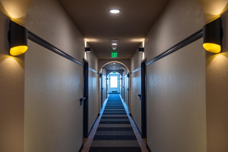 Hallways feature "porch lights" above doors in the new Oak 140 apartment building on Thursday in downtown Fort Collins.