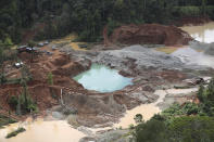 The land is deforested at an illegal gold mining operation where National Police and soldiers work to destroy it as part of the Armed Forces' "Operation Guamuez III" in Magui Payan, Colombia, Tuesday, April 20, 2021. Illegal gold mining is common in Colombia, especially wildcat mines in poverty-stricken areas dominated by criminal gangs with little state presence. (AP Photo/Fernando Vergara)