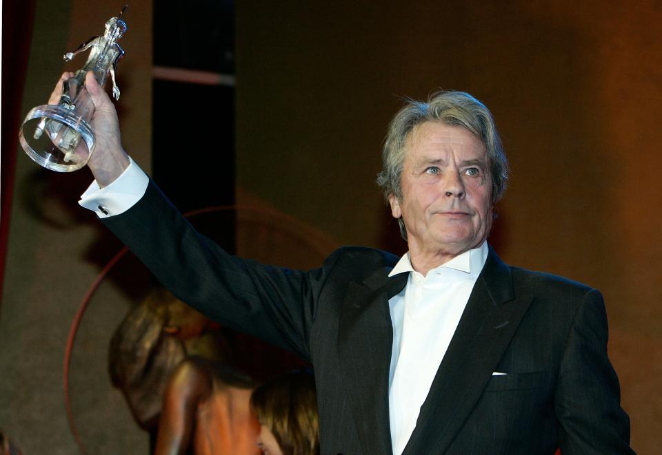 <p>MUNICH, GERMANY - JANUARY 26:  Actor Alain Delon shows his Lifetime Achievement Award at the end of the Diva Awards at the Deutsches Theater on January 26, 2006 in Munich, Germany.  (Photo by Jan Pitman/Getty Images)</p>
