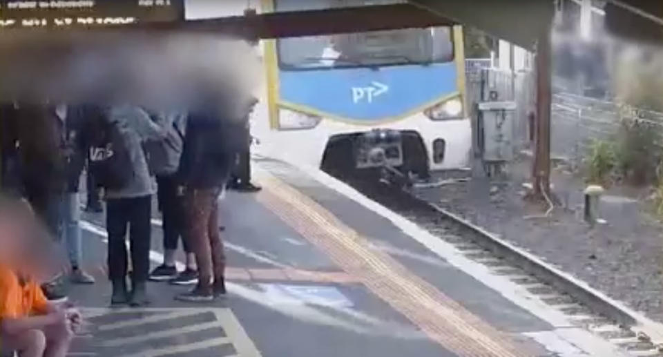 A train arrives mere seconds after the kids have rushed across. Source: Public Transport Victoria