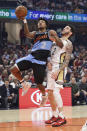 Cleveland Cavaliers' Collin Sexton, left, drives next to New Orleans Pelicans' Lonzo Ball during the first half of an NBA basketball game Tuesday, Jan. 28, 2020, in Cleveland. (AP Photo/Tony Dejak)