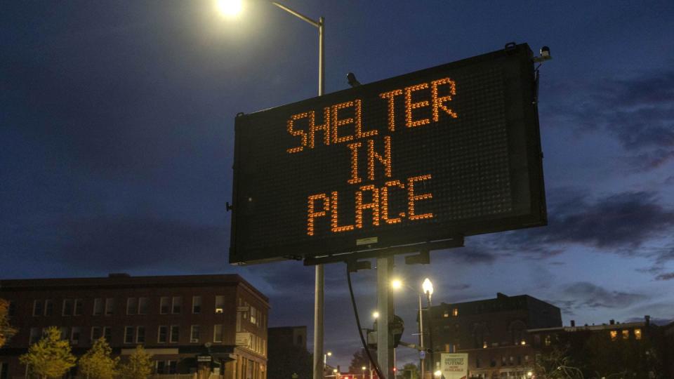 A sign advises residents to stay home, Thursday, Oct. 26, 2023, following a mass shooting at a restaurant and a bowling alley in Lewiston, Maine. Police continue to search for the suspect. (AP Photo/Robert F. Bukaty)