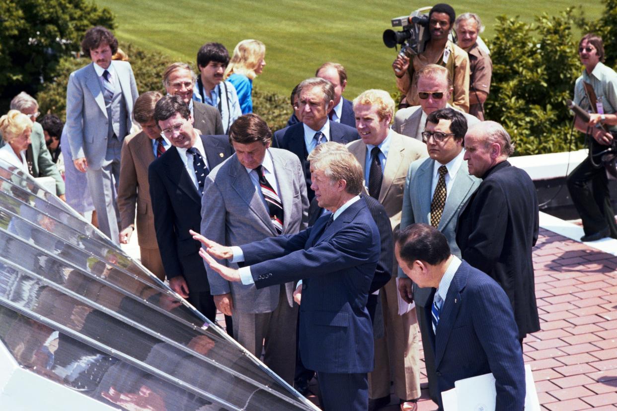 FILE: This archival photo from June 1979 shows President Jimmy Carter unveiling 32 thermal solar panels on the roof of the West Wing of the White House. Carter invested in early solar technology, helping pave the way for modern solar advancements.