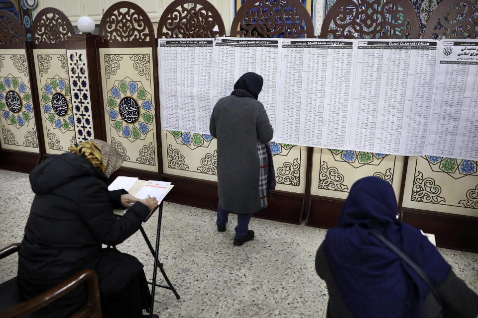 People visit a polling station for voting in the parliamentary elections, in Tehran, Iran, Friday, Feb. 21, 2020. Iranians began voting for a new parliament Friday, with turnout seen as a key measure of support for Iran's leadership as sanctions weigh on the economy and isolate the country diplomatically. (AP Photo/Vahid Salemi)