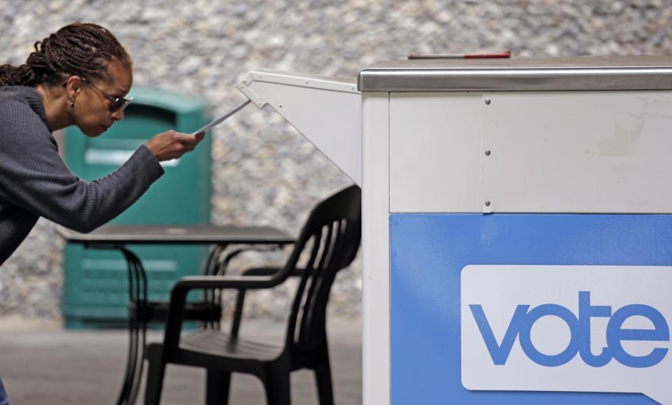 Eudora Carter carefully drops her ballot into a drop-off voting box Tuesday, Aug. 2, 2016, in Seattle. Washington's voters are weighing in on dozens of races across the state as they winnow their choices for offices ranging from Congress to the Legislature in the state's primary election. (Photo: Elaine Thompson/AP)