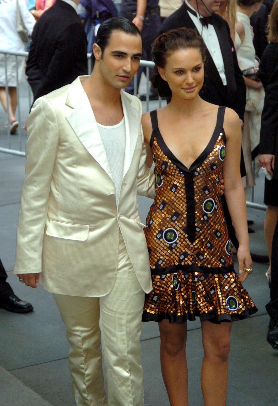 Zac Posen in a white suit and Natalie Portman in a metallic and black dress