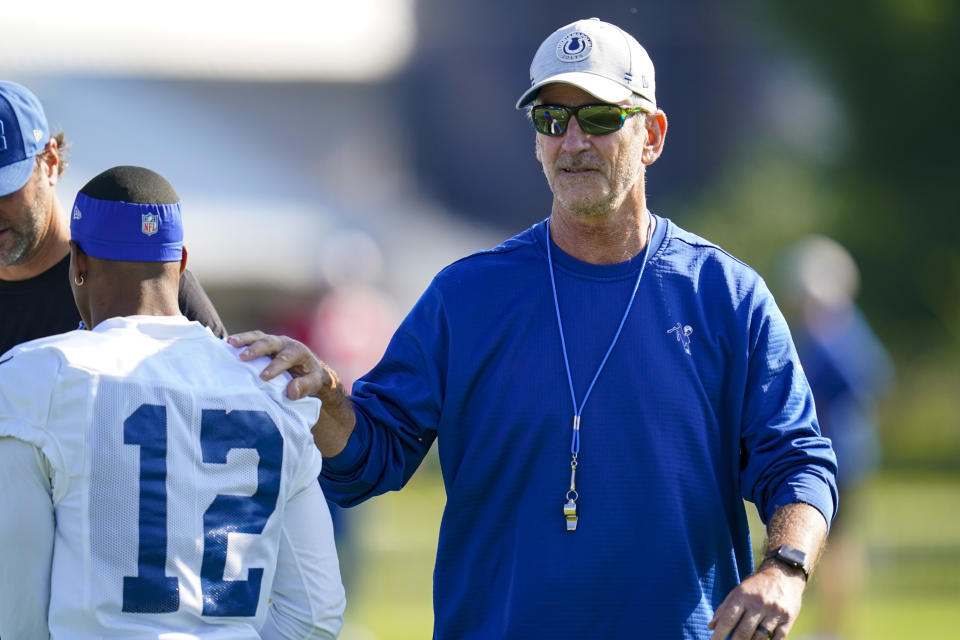 Indianapolis Colts head coach Frank Reich greets wide receiver DeMichael Harris before the start of practice at the NFL team's football training camp in Westfield, Ind., Monday, Aug. 2, 2021. Reich returned to practice following his quarantine period and two negative tests after a positive test for COVID-19. (AP Photo/Michael Conroy)