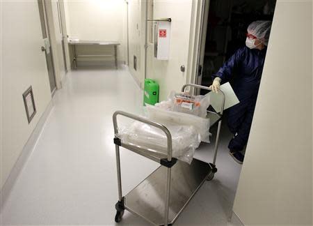 Laura Turner puts supplies away in a Northwest Biotherapeutics laboratory in Memphis, Tennessee, February 21, 2014. REUTERS/Mike Brown