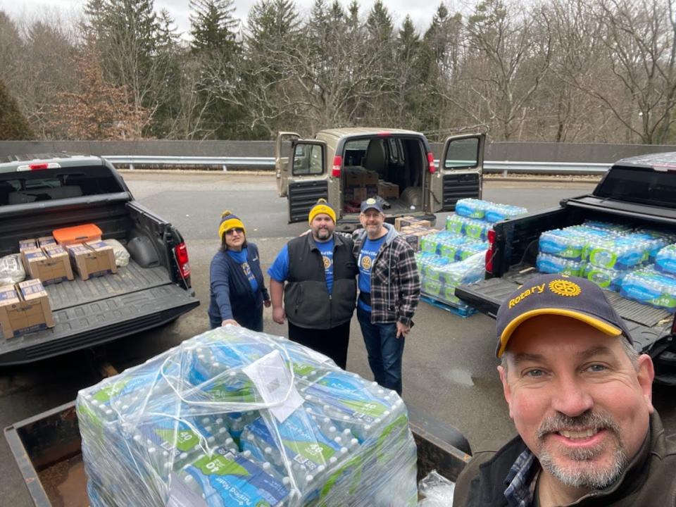 Rotary Club of Ellwood City members (left to right) Jean Barsotti, David Braymer, Bruce Thallman and Doug Slade deliver bottled water to The Way Station in East Palestine, Ohio.