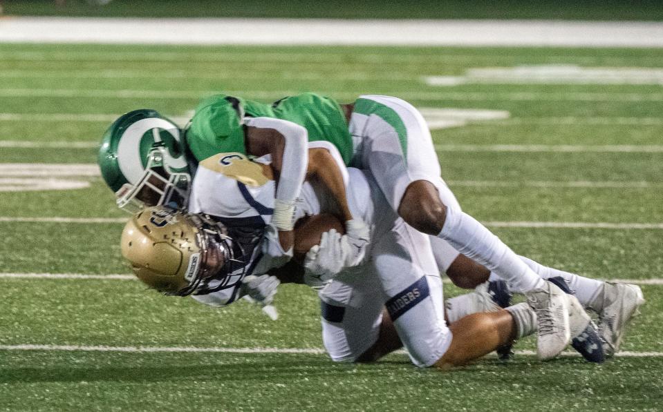 Central Catholic's Trace Hernandez, bottom, is tackled by St. Mary's Ahmyri McGee-Hall
during the so-called "Holy Bowl" varsity football game at St. Mary's Sanguinetti Field in Stockton on Aug. 25, 2023.