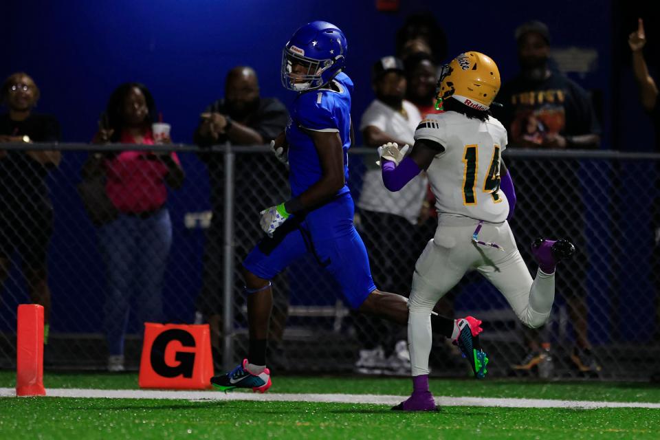 Riverside's Myles Kendrick (1) scores a touchdown against Ed White's Davonte Mango (14) during the third quarter.