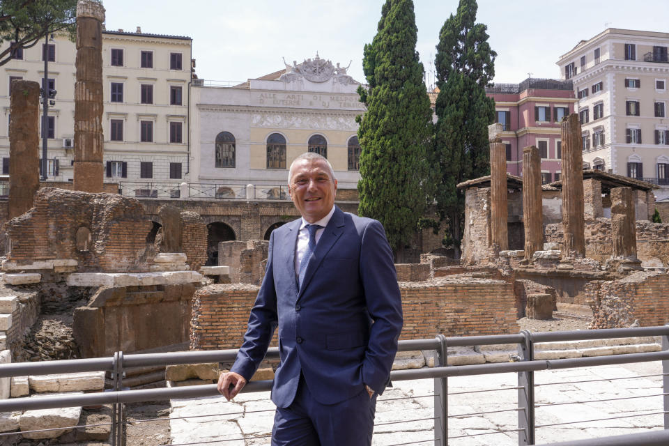 Bulgari CEO Jean-Christophe Babin poses in front of the so called 'Sacred Area' where four temples, dating back as far as the 3rd century B.C., stand smack in the middle of one of modern Rome's busiest crossroads, Monday, June 19, 2023, With the help of funding from Bulgari, the luxury jeweler, the grouping of temples can now be visited by the public that for decades had to gaze down from the bustling sidewalks rimming Largo Argentina (Argentina Square) to admire the temples below where Caesar masterminded his political strategies and was later fatally stabbed in 44 B.C. (AP Photo/Domenico Stinellis)