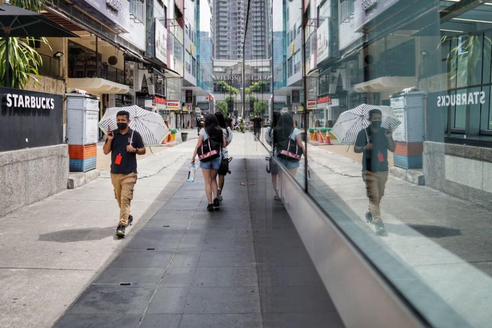 People are seen wearing protective masks as they walk along Jalan Bukit Bintang, Kuala Lumpur October 17, 2021. — Picture by Ahmad Zamzahuri