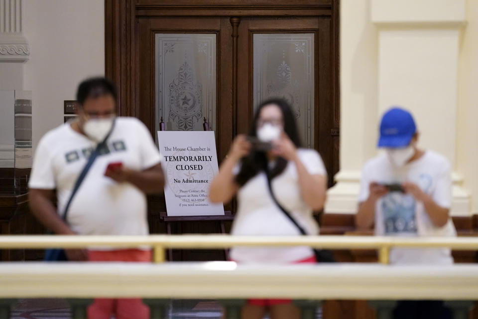 Visitors take photos near the "Temporarily Closed" doors to the House Chamber at the State Capitol, Tuesday, June 1, 2021, in Austin, Texas. The Texas Legislature closed out its regular session Monday, but are expected to return for a special session after Texas Democrats blocked one of the nation's most restrictive new voting laws with a walkout. (AP Photo/Eric Gay)