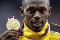 FILE - Jamaica's Usain Bolt poses with his gold medal for the men's 100-meters during the athletics in the Olympic Stadium at the 2012 Summer Olympics, London, Monday, Aug. 6, 2012. (AP Photo/Matt Slocum, File)