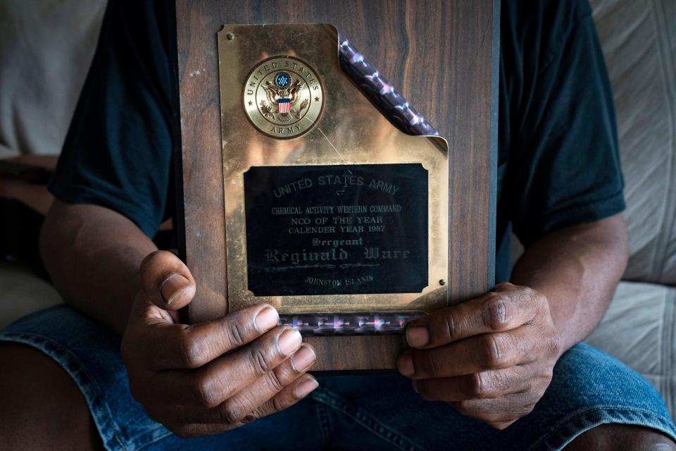 Army veteran Reginald Ware holds an award he received in 1987 as Chemical Activity Western Command NCO of the Year.