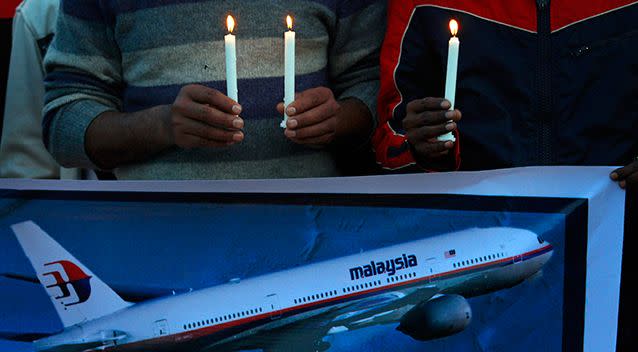 Members of the social group Christian Muslim Alliance Pakistan take part in a candlelight vigil for passengers that were aboard a missing Malaysia Airlines plane. Photo: AP