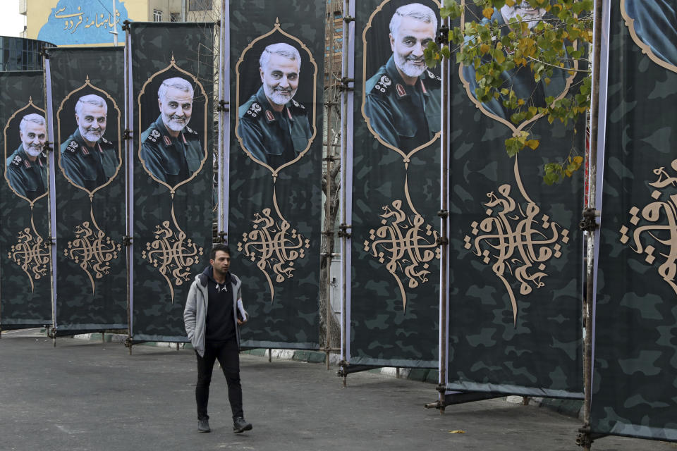 A pedestrian walks past banners showing portrait of Iranian Revolutionary Guard Gen. Qassem Soleimani, who was killed in a U.S. airstrike early Friday in Iraq, in Tehran, Iran, Saturday, Jan. 4, 2020. (AP Photo/Vahid Salemi)