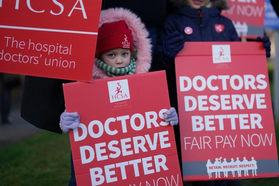 A child joins striking NHS junior doctors on the picket line outside Leicester Royal Infirmar (PA)