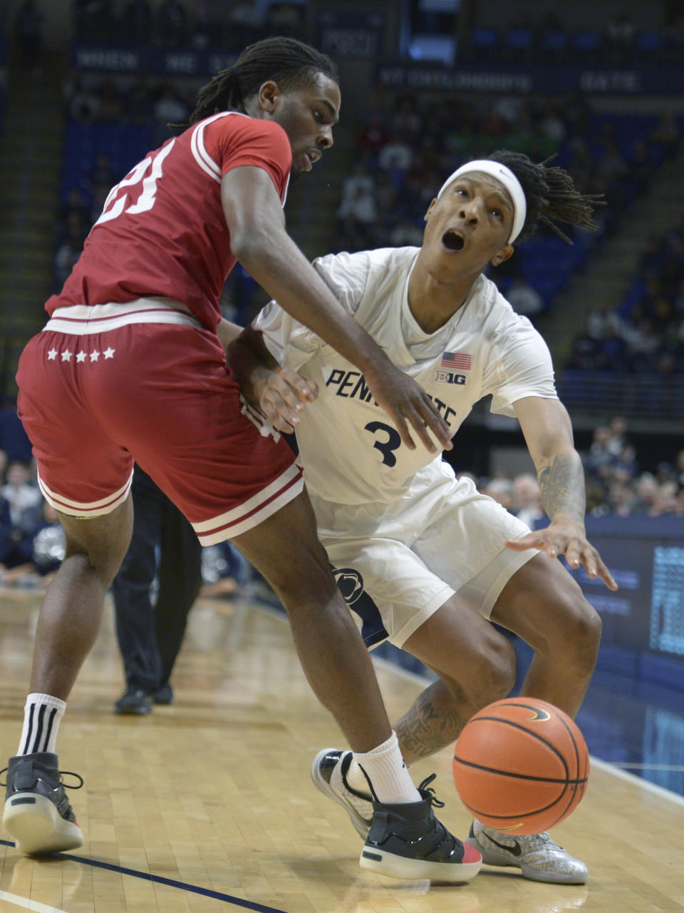 Penn State's Nick Kern Jr., right, is fouled by Indiana's Mackenzie Mgbako (21) during the first half of an NCAA college basketball game Saturday Feb. 24, 2024, in State College, Pa. (AP Photo/Gary M. Baranec)