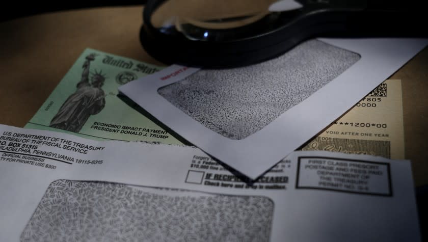 FILE- In this April 23, 2020, file photo a stimulus check issued by the IRS to help combat the adverse economic effects of the COVID-19 outbreak is shown in San Antonio. Compounding the hardships of coronavirus, some nursing homes have demanded that low-income residents turn over their $1,200 economic stimulus checks. On Tuesday, June 9, Sens. Chuck Grassley, R-Iowa, and Ron Wyden, D-Ore., called on the Health and Human Services inspector general's office to issue a warning to nursing homes and assisted living facilities that such practices are "improper and unlawful." (AP Photo/Eric Gay, File)