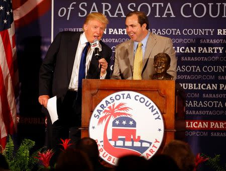 Donald Trump (L) cuts short an introduction by Joe Gruters, Chairman of the Republican Executive Committee of Sarasota County before Trump was presented as its Statesman of the Year in Sarasota, Florida August 26, 2012. REUTERS/Mike Carlson