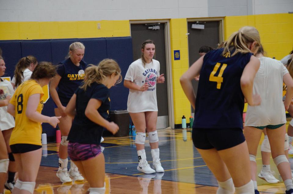 Senior Alexis Kozlowski (white shirt) goes through a drill during tryouts on Tuesday, August 8.