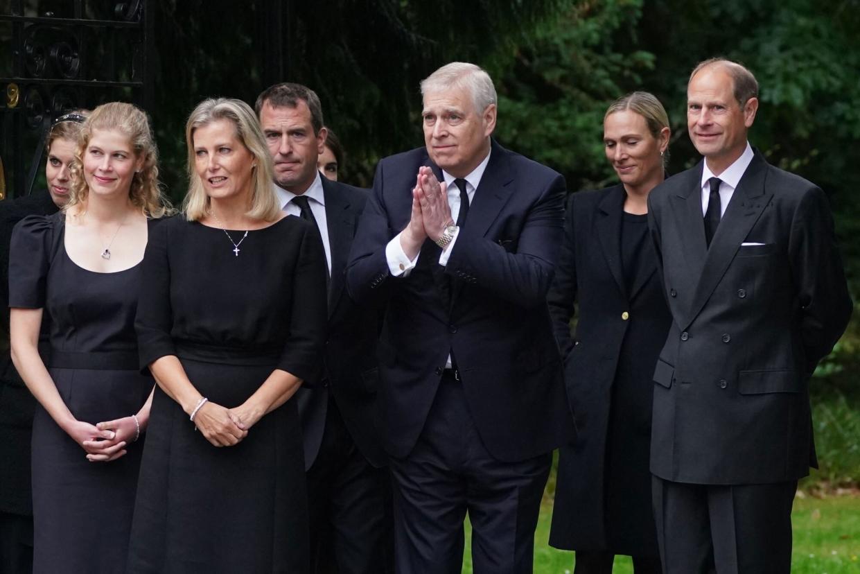 Britain's Princess Beatrice of York (L), Britain's Lady Louise Windsor (2L), Britain's Sophie, Countess of Wessex (3L), Peter Phillips (4L), Britain's Princess Eugenie of York (obscured), Britain's Prince Andrew, Duke of York (C), Zara Phillips (2R) and Britain's Prince Edward, Earl of Wessex greet members of the public gathered outside of Balmoral Castle in Ballater, on September 10, 2022, two days after Queen Elizabeth II died at the age of 96. - King Charles III pledged to follow his mother's example of "lifelong service" in his inaugural address to Britain and the Commonwealth on Friday, after ascending to the throne following the death of Queen Elizabeth II on September 8. (Photo by Owen Humphreys / AFP) (Photo by OWEN HUMPHREYS/AFP via Getty Images)