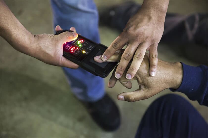 This undated photo obtained from Immigration and Customs Enforcement (ICE) shows a NeoScan 45 fingerprint scanner. The device, paired with an app known as EDDIE, is used by ICE to run remote ID checks. The app has been a core tool in President Donald Trump's deportation crackdown, according to a new report based on a Freedom of Information Act lawsuit. (Immigration and Customs Enforcement via AP)