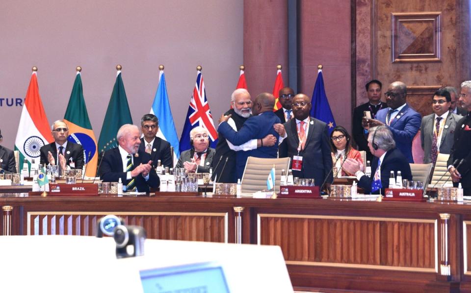 Modi embracing Comoros president and African Union chair Azali Assoumani (C-R) after welcoming him to take up a permanent chair at the G20 table (EPA)